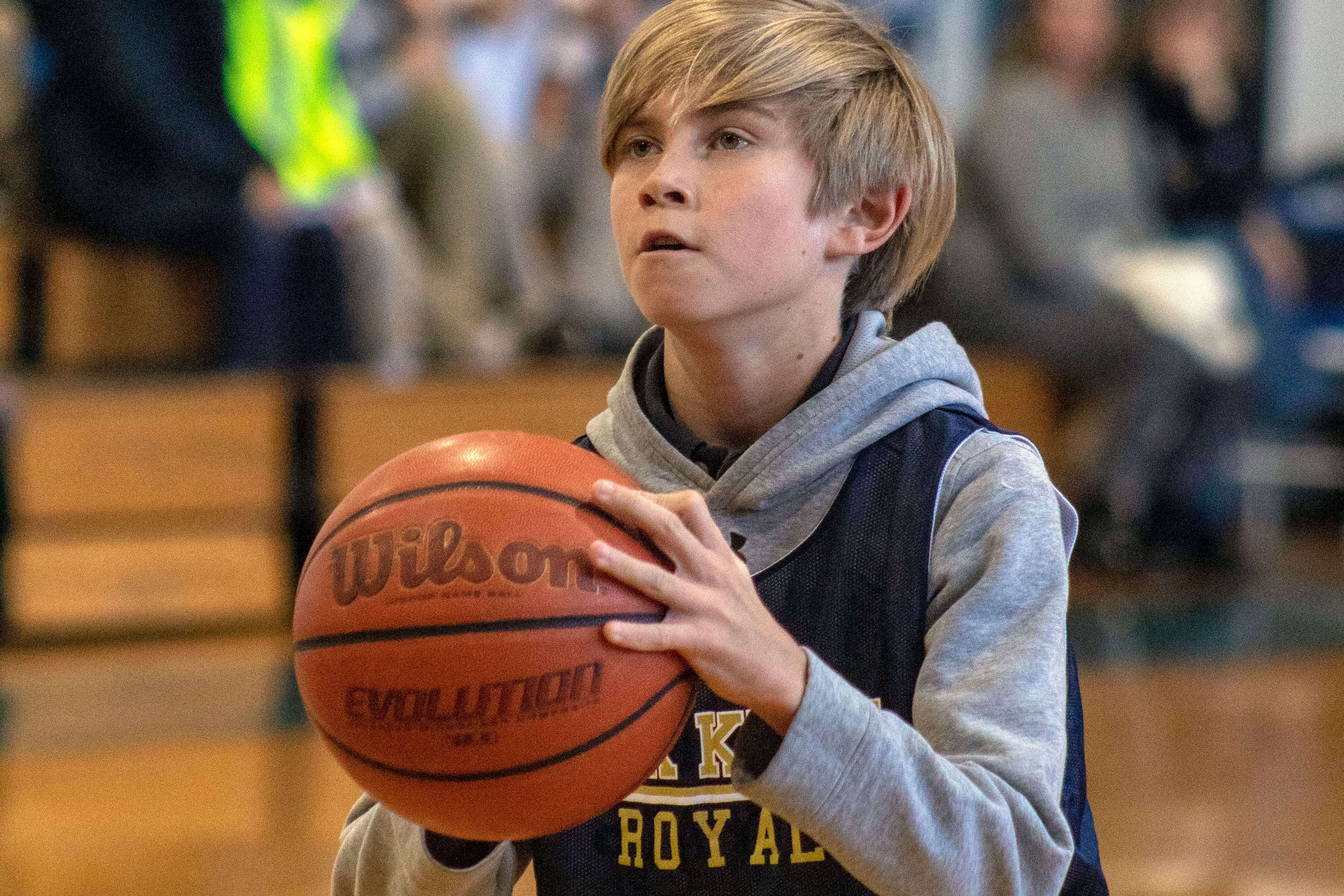 Lower School boy preparing to take a shot during an Oak Knoll basketball game