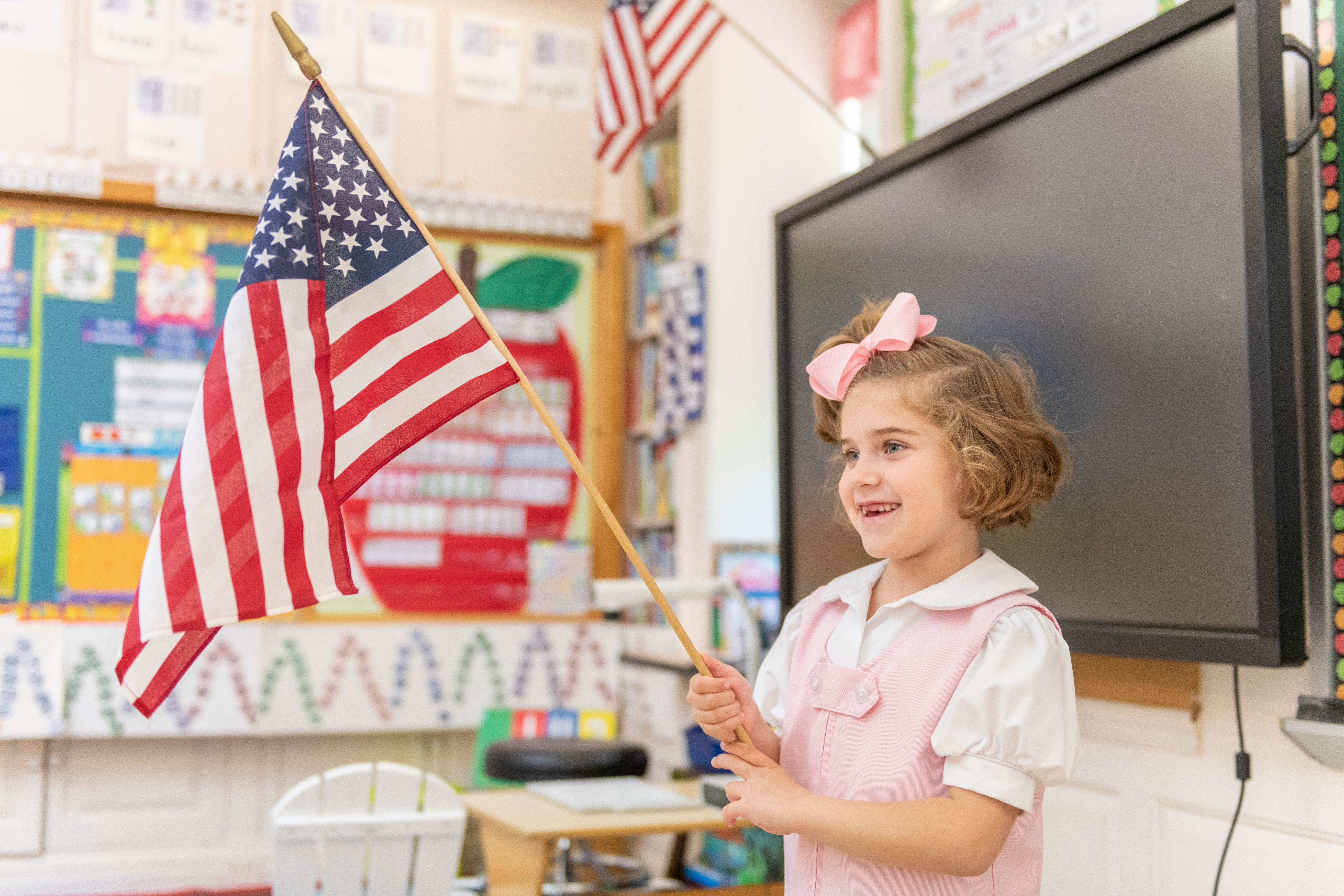 Lower School Girl Holding American Flag at Oak Knoll