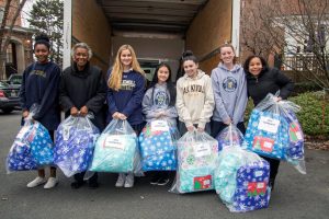 upper school students collecting donations for those less fortunate.