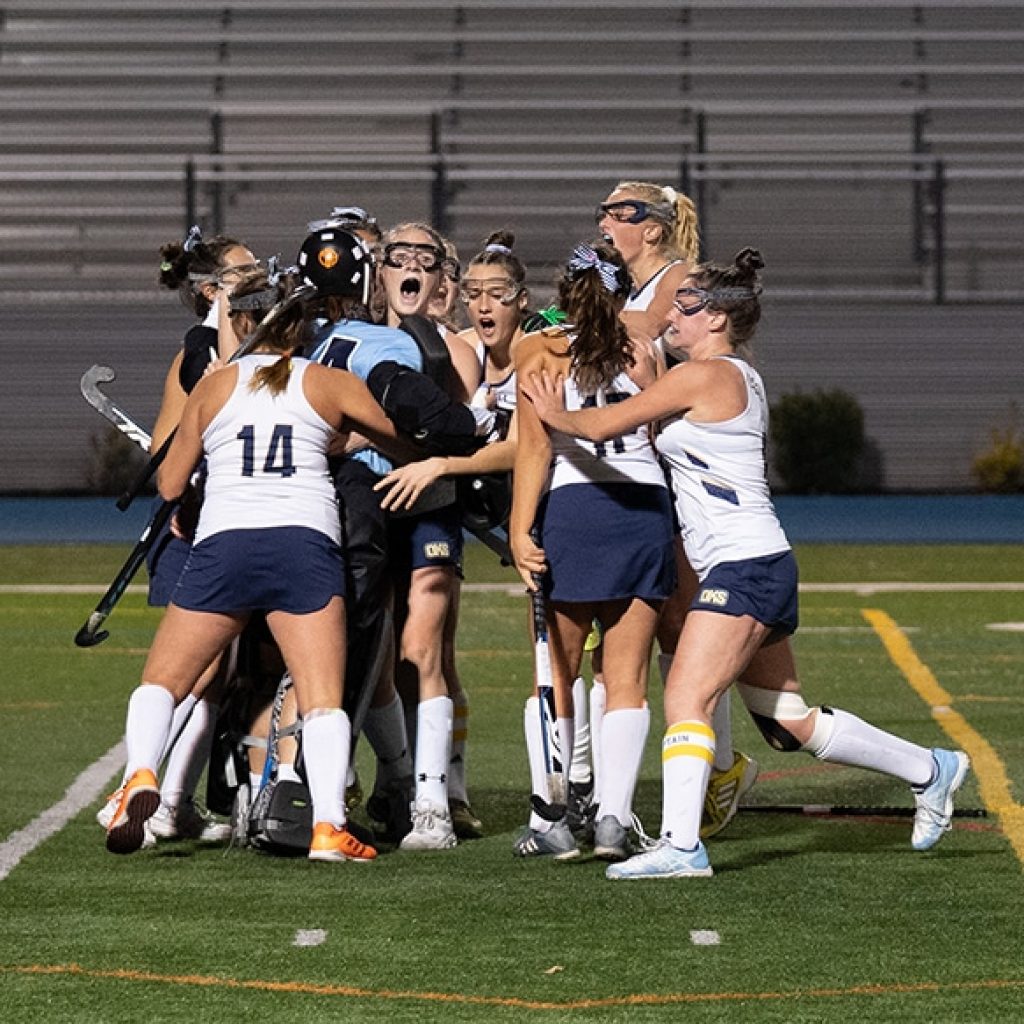 field hockey team celebrates after tournament of champions victory