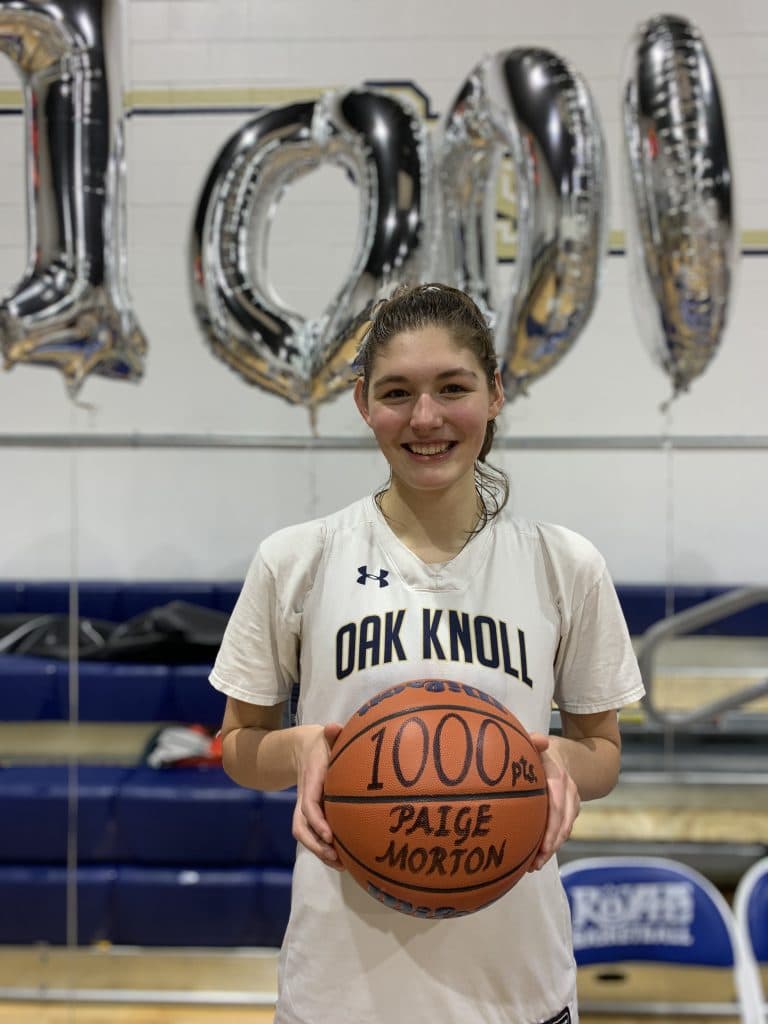 Paige Morton '20 pictured after scoring her 1000th point for oak knoll school