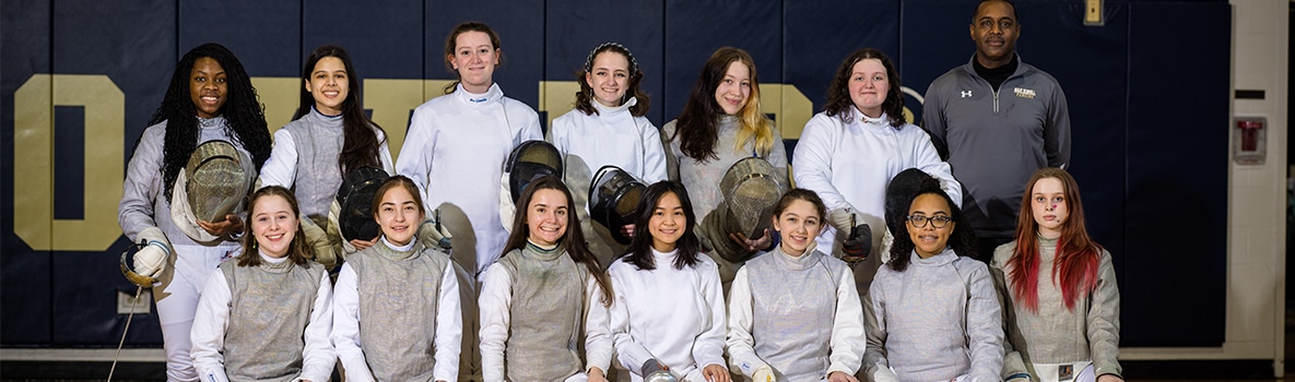 Team photo of fencing team in two rows.