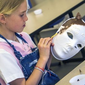 Student paints mask during art class.