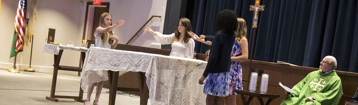 Students set up altar during annual grade 6 commencement Mass.