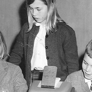 Historical image of students using counting machines from either the 1950s or 1960s.