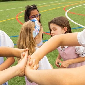 Students play hand clapping game during recess.