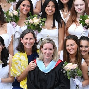 Head of School and Division Head smile along with members of the senior class during 2022 Commencement.
