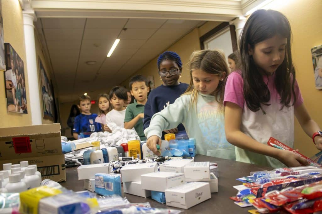 young students stuffing hygiene bags